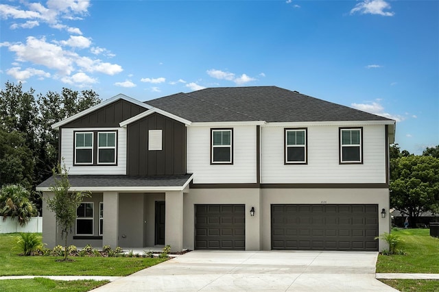 view of front of home featuring a front yard and a garage