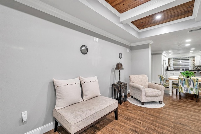 living area featuring wood-type flooring, wooden ceiling, ornamental molding, and beam ceiling