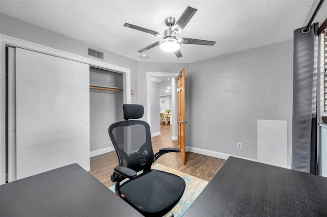 office area with dark hardwood / wood-style flooring and ceiling fan