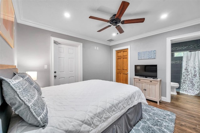 bedroom with ceiling fan, ornamental molding, dark wood-type flooring, and connected bathroom