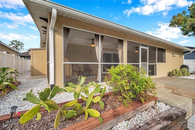 rear view of house featuring a sunroom