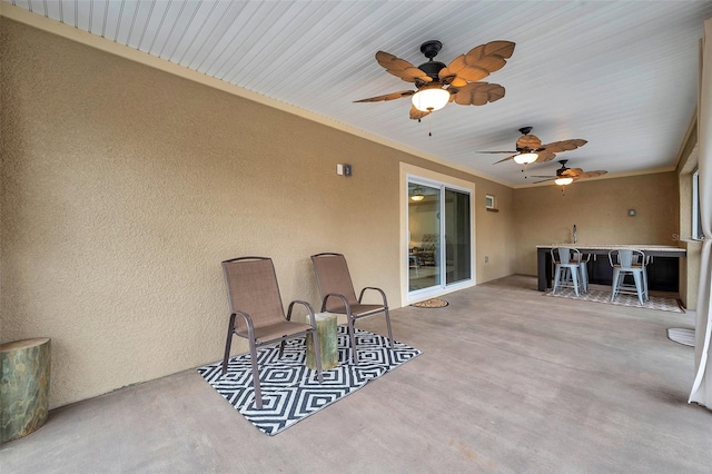 view of patio / terrace with ceiling fan and exterior bar