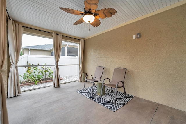 sunroom featuring ceiling fan