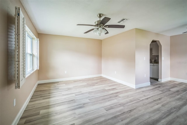 empty room with ceiling fan and light hardwood / wood-style floors