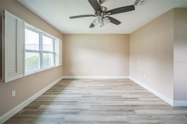 spare room featuring light hardwood / wood-style flooring and ceiling fan