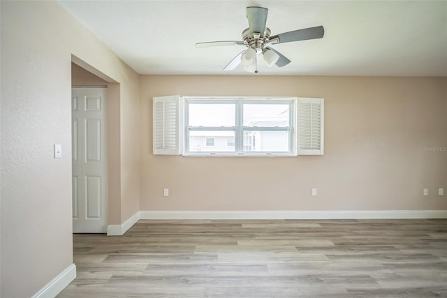 empty room with ceiling fan and light wood-type flooring