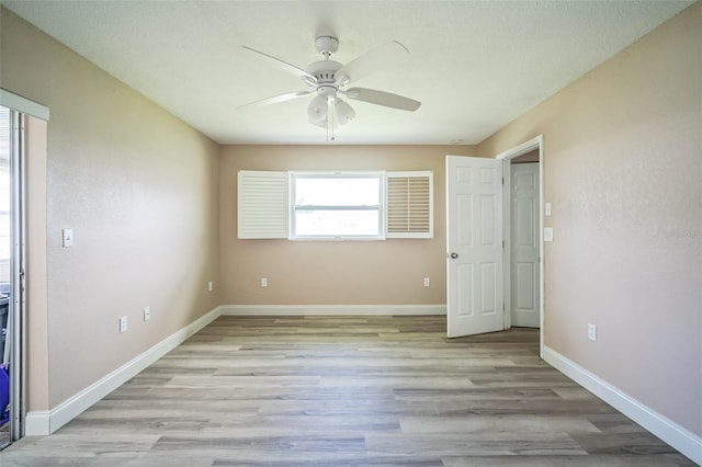 unfurnished bedroom featuring ceiling fan and light wood-type flooring