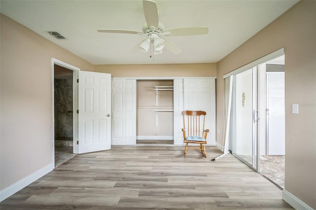 unfurnished room featuring ceiling fan, light hardwood / wood-style floors, and a wealth of natural light