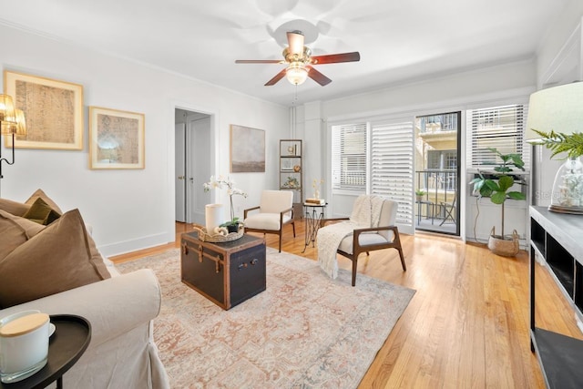 living room featuring ceiling fan, ornamental molding, and hardwood / wood-style floors