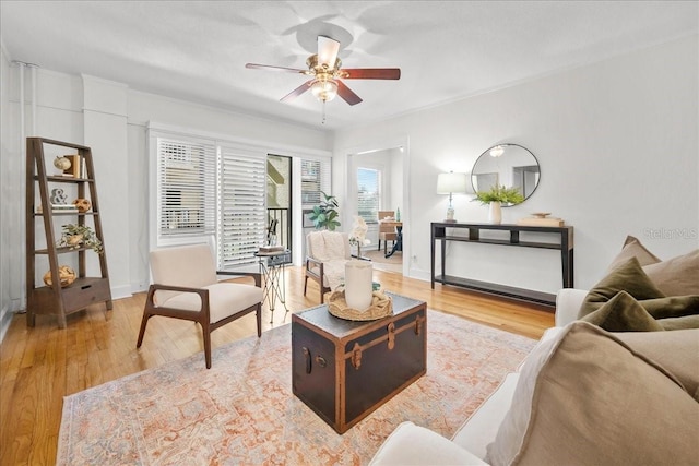 living room featuring wood-type flooring and ceiling fan