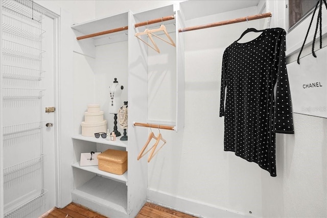 walk in closet with wood-type flooring