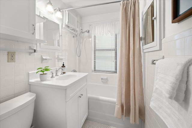 full bathroom with tile walls, vanity, shower / bath combination with curtain, and toilet