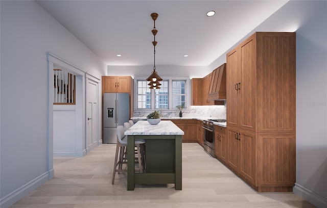 kitchen with premium range hood, a kitchen island, a breakfast bar, decorative light fixtures, and high end appliances