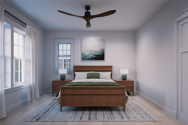 bedroom featuring multiple windows, light hardwood / wood-style floors, and ceiling fan