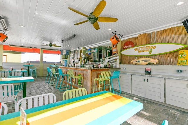 view of patio with an outdoor bar and ceiling fan