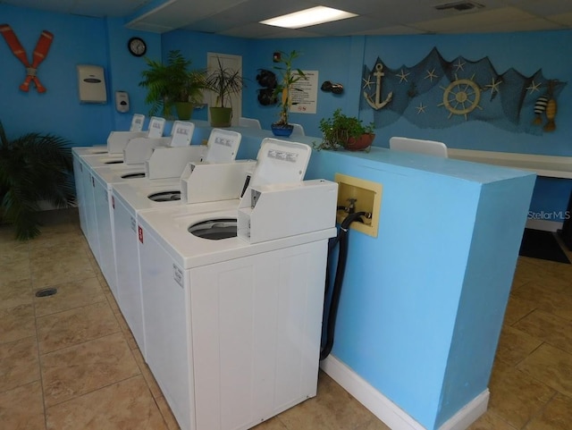 washroom featuring washer and dryer and light tile patterned flooring