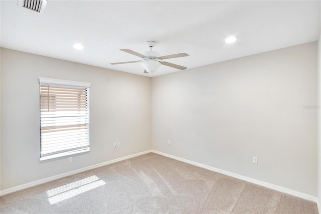 spare room featuring ceiling fan and carpet