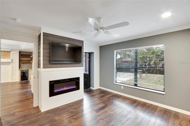 unfurnished living room with crown molding, dark wood-type flooring, and beverage cooler