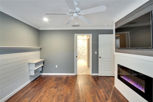 unfurnished living room with dark wood-type flooring, ceiling fan, and ornamental molding