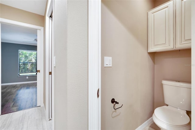 bathroom with ceiling fan and toilet