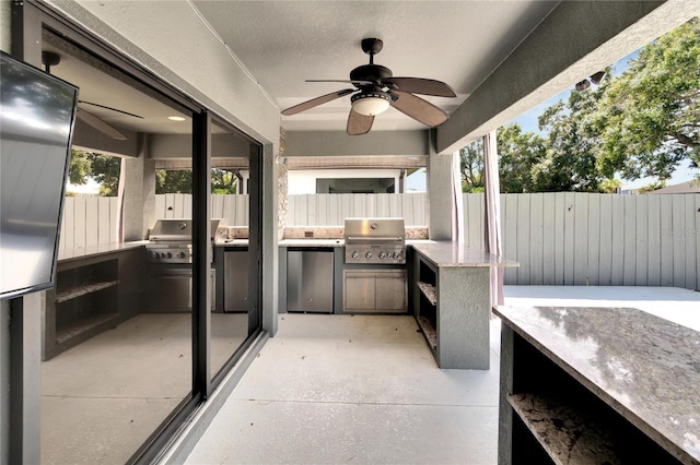 view of patio / terrace with ceiling fan, an outdoor kitchen, and grilling area