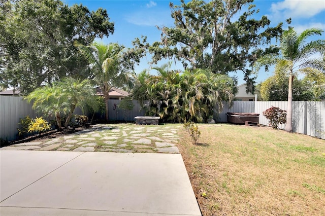 view of yard with a hot tub and a patio