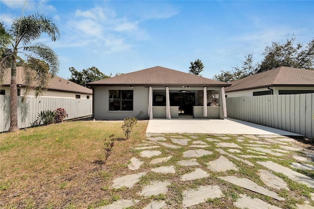 back of property featuring a patio area and a lawn