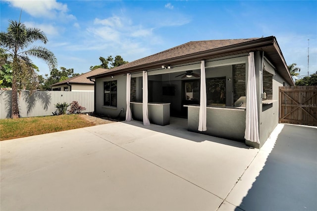 back of house with a patio area and ceiling fan