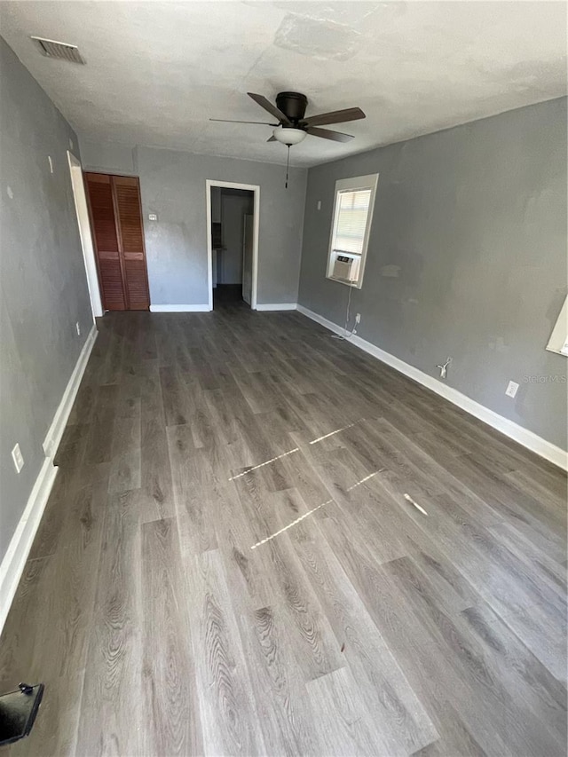 interior space featuring cooling unit, hardwood / wood-style floors, and ceiling fan