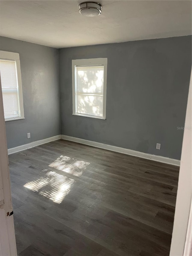 empty room featuring dark hardwood / wood-style flooring