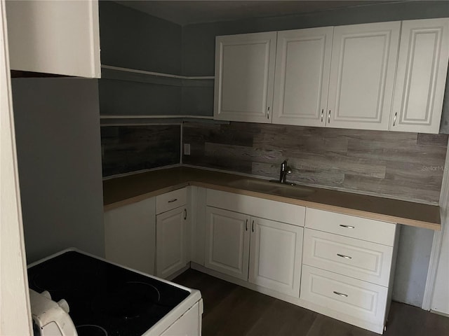 kitchen with sink, white cabinets, dark hardwood / wood-style flooring, and white electric range