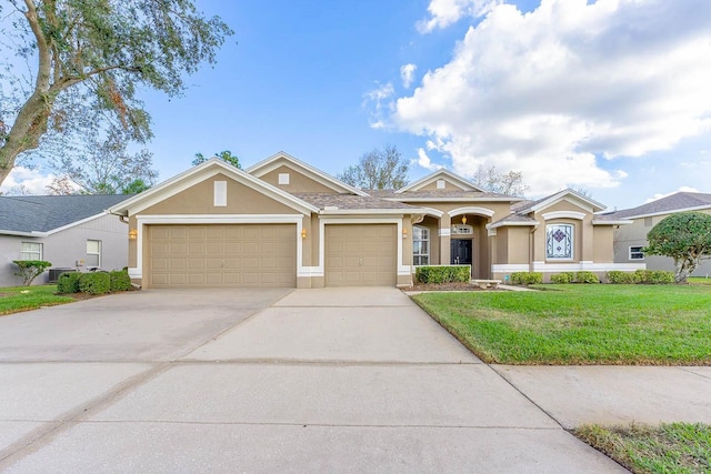 view of front of house with a front yard and a garage