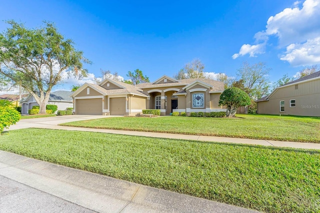 view of front of house featuring a garage and a front yard