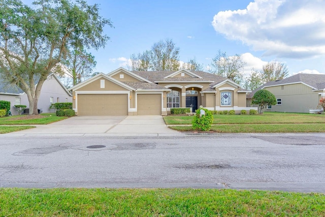 ranch-style house featuring a front lawn and a garage