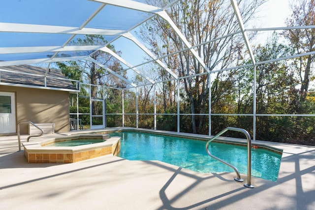 view of swimming pool with a lanai, a patio, and an in ground hot tub