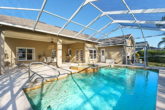 view of swimming pool with an in ground hot tub, french doors, a lanai, ceiling fan, and a patio area