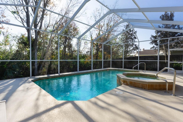 view of pool featuring a lanai, a patio area, and an in ground hot tub