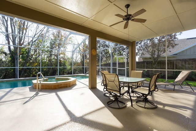 view of patio featuring a pool with hot tub and glass enclosure