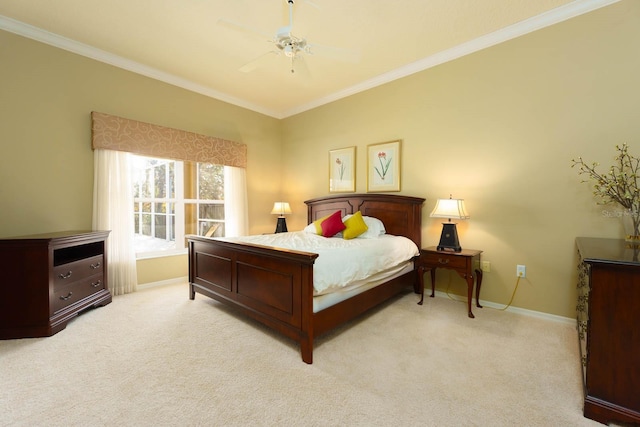 carpeted bedroom featuring ceiling fan and crown molding