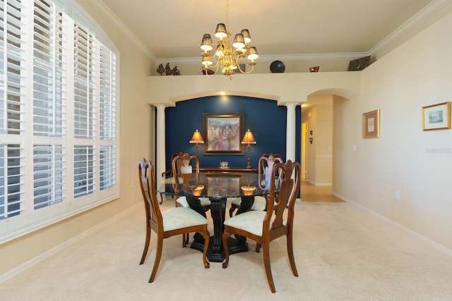 dining area featuring ornate columns, carpet flooring, ornamental molding, and a notable chandelier