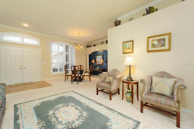 living area with ornamental molding, a notable chandelier, and carpet