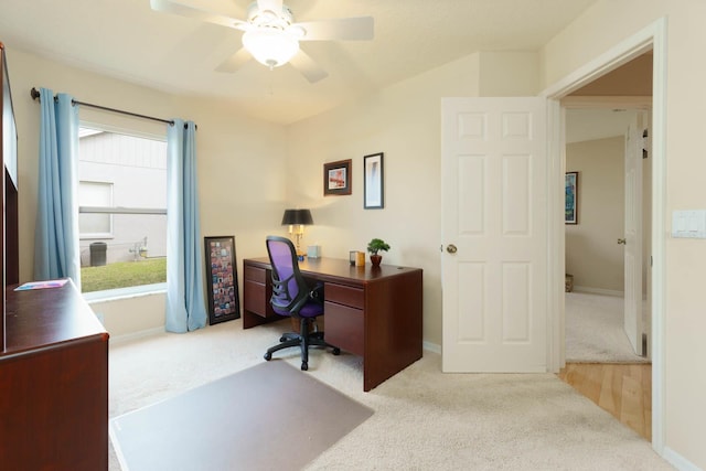 home office featuring light carpet and ceiling fan