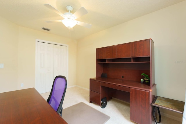 office space with ceiling fan and light carpet