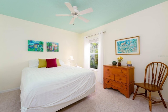 bedroom with ceiling fan and light carpet