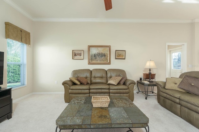 carpeted living room featuring ceiling fan and crown molding