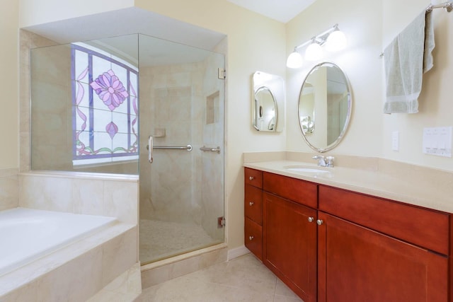 bathroom with tile patterned floors, independent shower and bath, and vanity