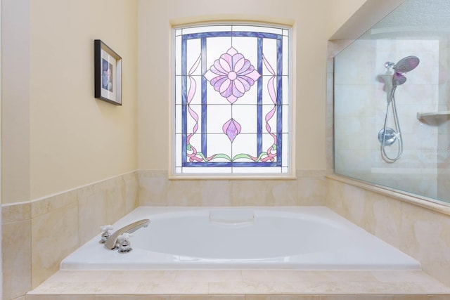 bathroom with a relaxing tiled tub