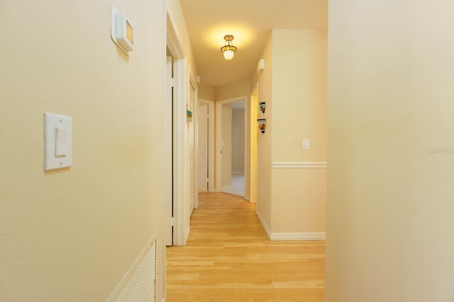 corridor with light wood-type flooring