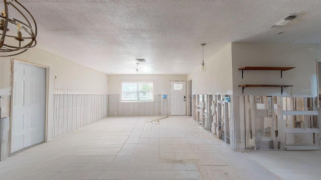 unfurnished room with a textured ceiling