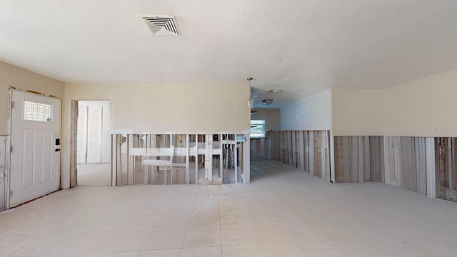 unfurnished room with a textured ceiling